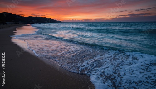 Fototapeta Naklejka Na Ścianę i Meble -  Dark ocean wave crashing onto the shore, showcasing the power of nature
