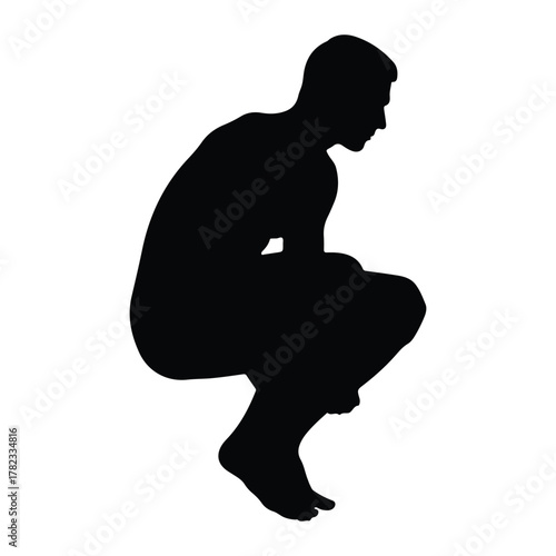 Silhouette of a man crouching in a thoughtful pose