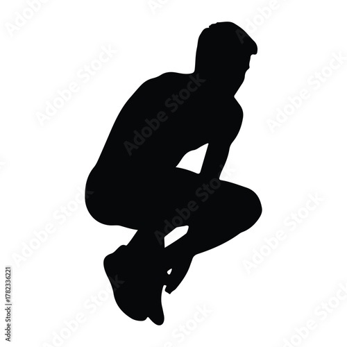 Silhouette of a man in a crouching or squatting pose