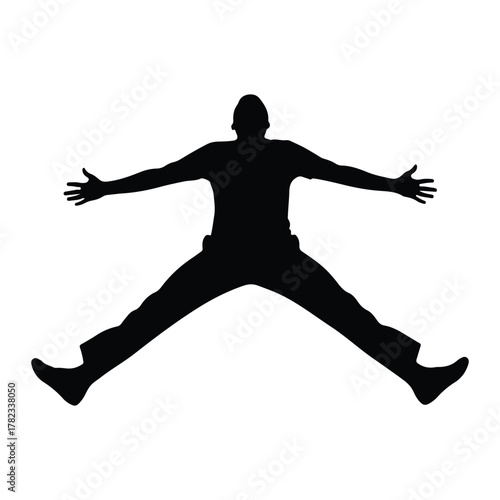 Silhouette of a man jumping with legs spread wide male