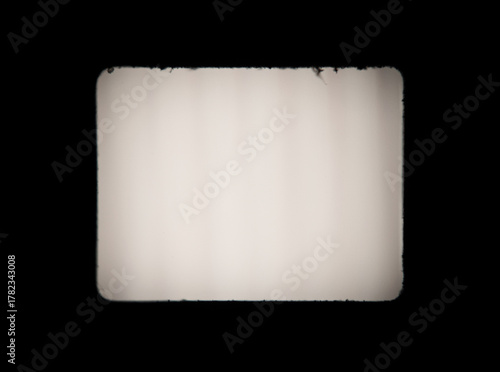 Old, blank projector film frame isolated on black background with copy space © rangizzz