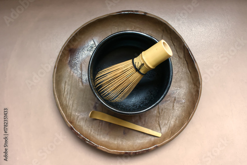 Green tea powder with a tea whisk in a bowl