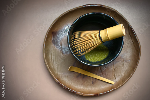 Green tea powder with a tea whisk in a bowl