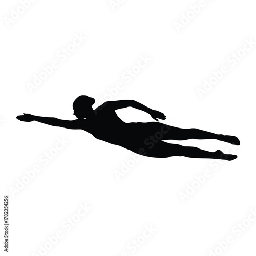 Silhouette of a swimmer in a powerful stroke swimming