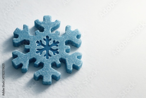 Puzzle shaped like snowflake on concrete surface symbolizing connection uniqueness and complexity ideal for teamwork winter campaigns and identity branding