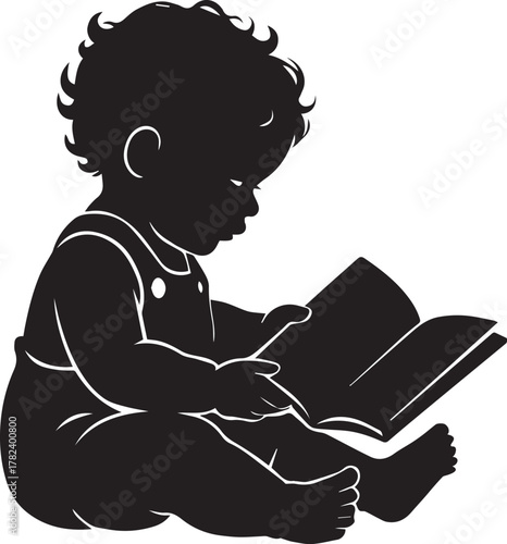 Silhouette of a young child with curly hair sitting and engrossed in reading a book