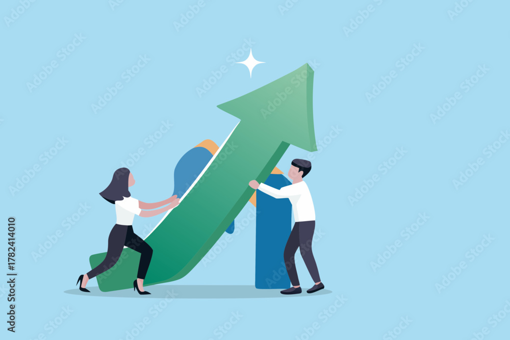 Fototapeta premium Two business people working together to push a large green upward trending arrow symbolizing growth and success