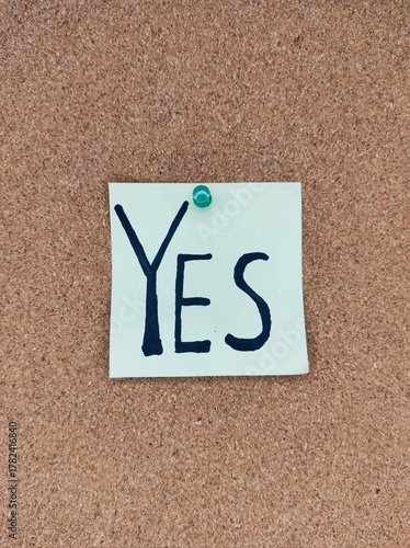 Handwritten YES note on cork board – self-confidence and encouragement message