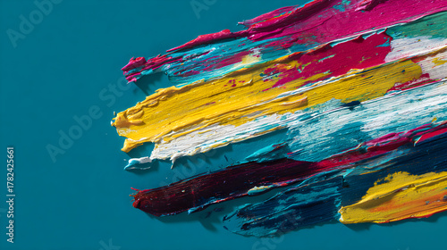 Colorful paint strokes on a textured surface creating an artistic abstract composition