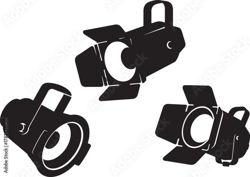 Three black silhouette stage lighting spotlights isolated on transparent background