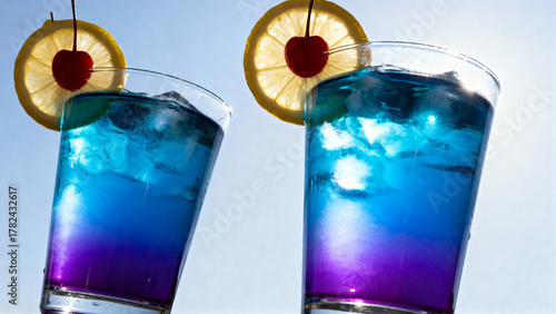 Blue cocktails with lemon and cherry