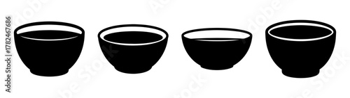 Four black ceramic tea cups with white rims, arranged in a row on a