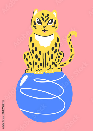 Spotted leopard sitting on a tumbling ball, circus performance with wild cat on pink background