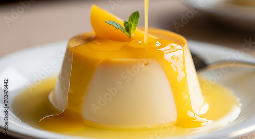 Milk pudding with yellow fruit sauce