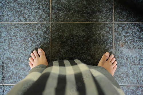 Barefoot freedom on cool tile floors, a moment of relaxation and simple comfort in a tranquil space perfect for wellness or lifestyle concepts