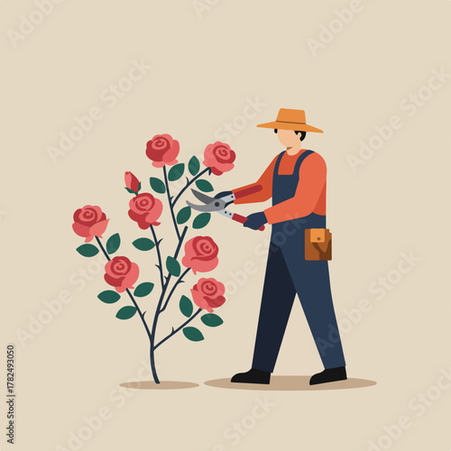 A gardener prunes a rose bush. They wear an orange shirt, blue overalls, and a hat. The rose blooms are red