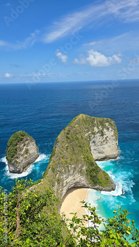 promontory overlook with twin islets, secluded tropical cove Nusa Penida Kelingking Beach Bali 