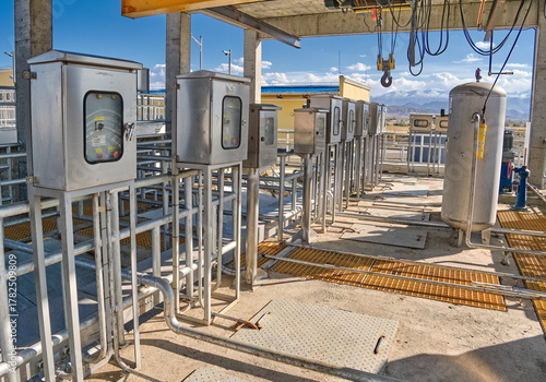 WWTP/WTP Automation system site: control cabinets, compressed air receiver, and piping for settling process control.