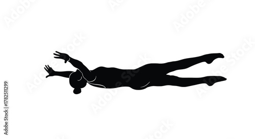 Silhouette of a female swimmer in a prone position, arms extended forward, legs trailing behind