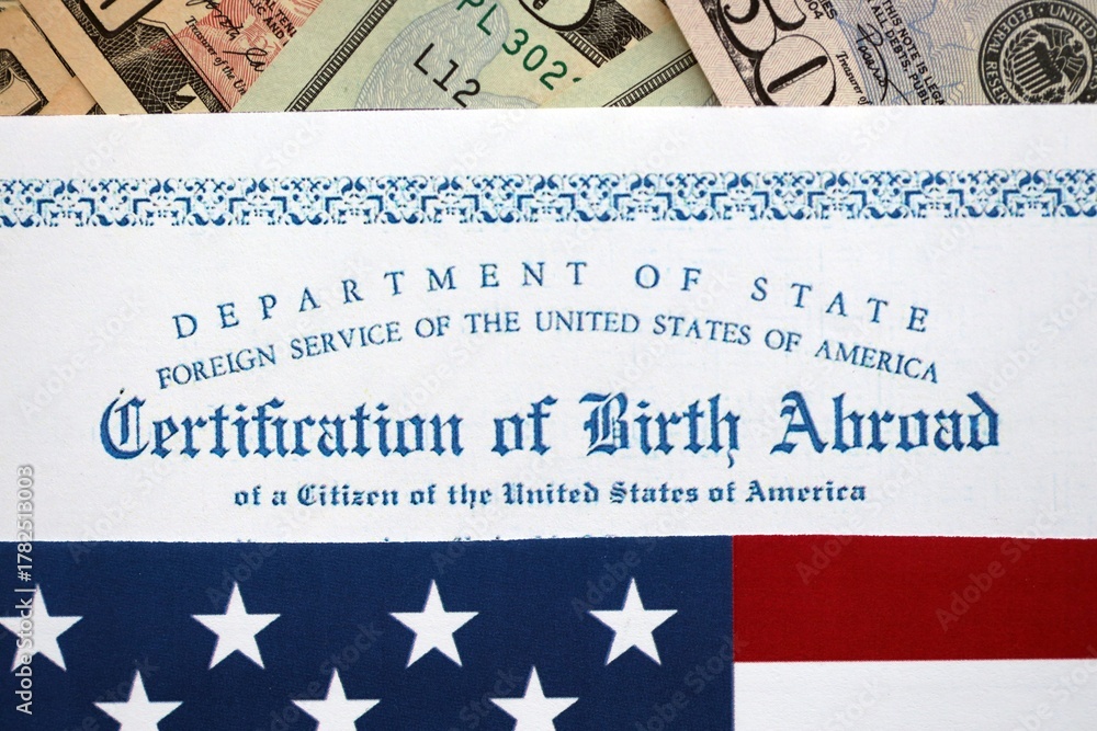 Fototapeta premium Certification of Birth Abroad with US flag and US dollar money bills close up