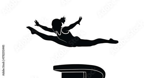 Silhouette of a female gymnast performing a vault over a pommel horse the gymnast is in midair, legs split
