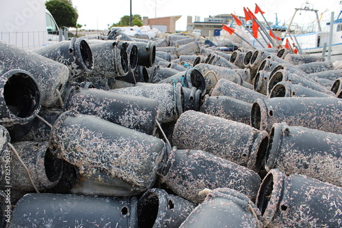 Fototapeta Naklejka Na Ścianę i Meble -  Close-up view of traditional octopus fishing pots (nasas) covered with marine growth and stacked in the harbor of Santa Pola, Alicante, Spain Showing authentic details of Mediterranean coastal fishing