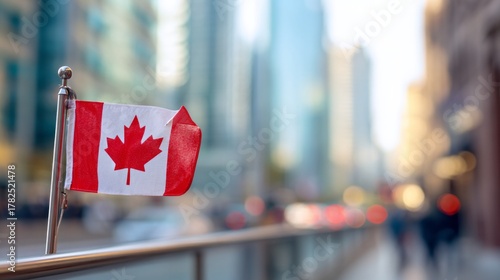 Fototapeta Naklejka Na Ścianę i Meble -  Small national banner displayed prominently on an urban railing with a blurred city background