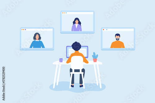 Person working remotely on a video conference call with colleagues from home office setup