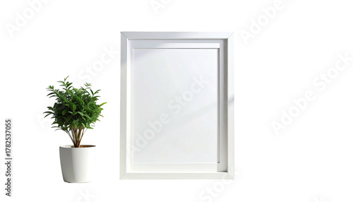 Wallpaper Mural A blank white picture frame stands beside a small potted plant against a stark black background Torontodigital.ca