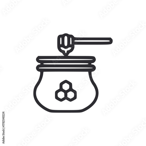 Honey jar with dipper atop