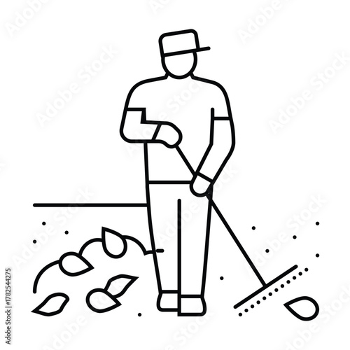 Man raking leaves wearing a hat