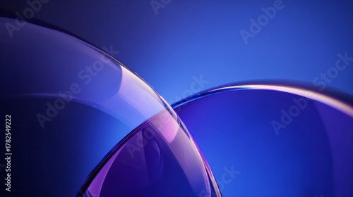 Smooth, overlapping glass surfaces create an abstract background with deep blue illumination