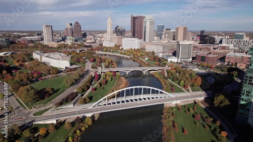 American midwestern city buildings, towers, and business of Columbus, OH in central Ohio with Scioto Mile, Franklinton, and downtown center buildings along river during a sunny fall and autumn day
