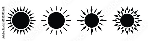 Four stylized black suns with radiant rays representing solar energy and celestial power
