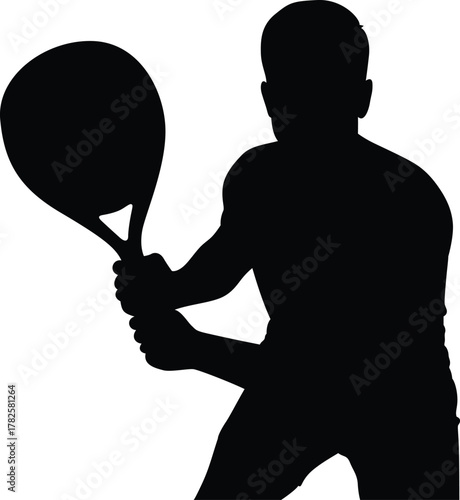 Silhouette of a male tennis player in action holding a racket ready to hit a ball