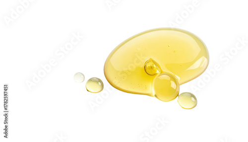 Close-up of a viscous, golden yellow liquid with droplets on black background