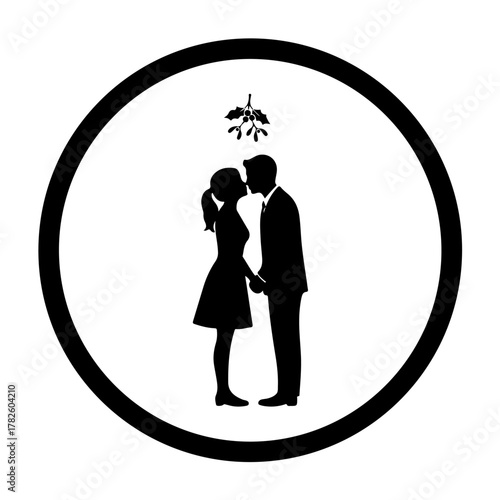 Sweet romantic couple kissing under mistletoe for festive Christmas holiday love and seasonal celebration