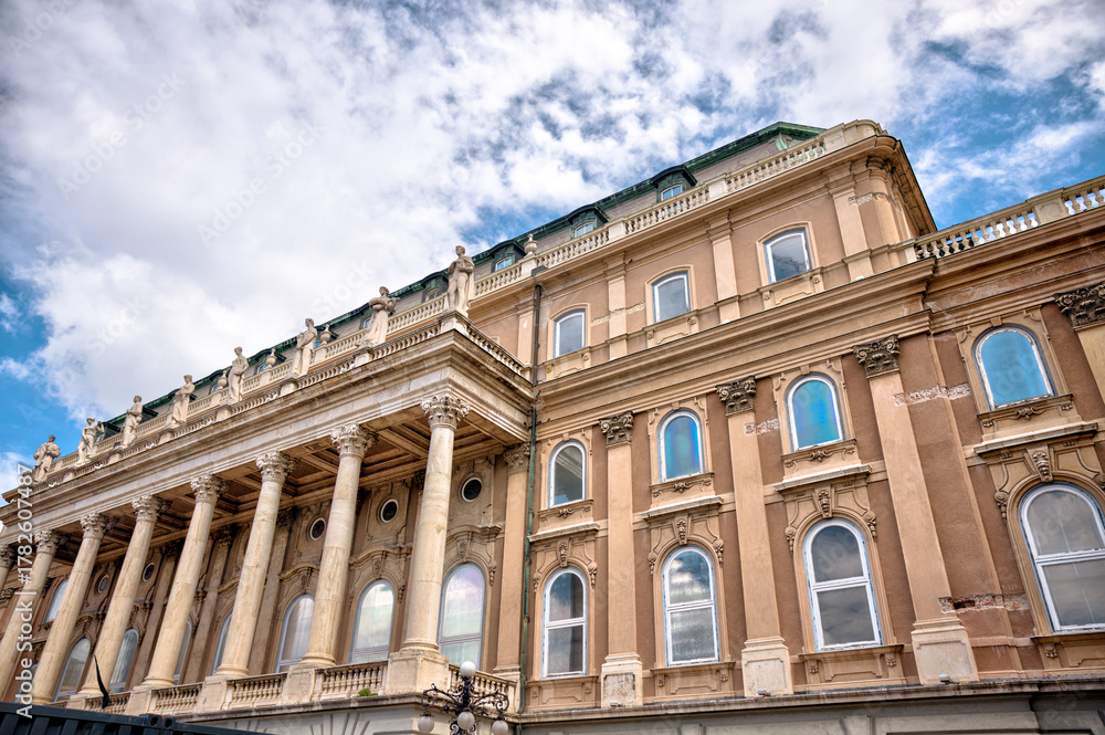 Obraz premium Budapest, Hungary - July 28, 2025: Exteriors of the Budapest Castle — a restored Neo-Renaissance building complex in Budapest, Hungary, located on the Buda side of the Danube 