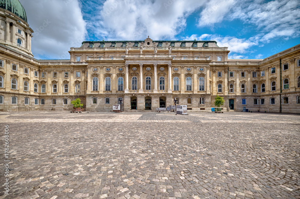 Obraz premium Budapest, Hungary - July 28, 2025: Exteriors of the Budapest Castle — a restored Neo-Renaissance building complex in Budapest, Hungary, located on the Buda side of the Danube 
