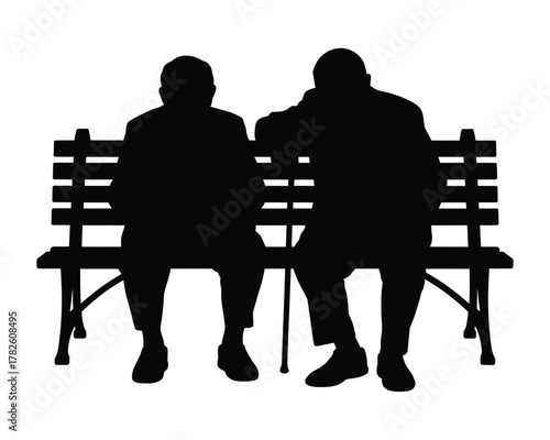 Two silhouetted figures sitting on a park bench with a cane