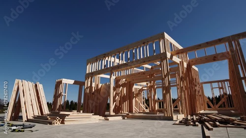 Timelapse of wooden house frame construction under clear blue sky