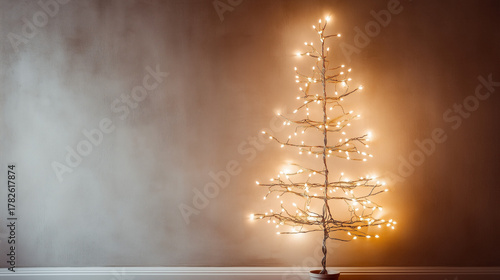 Wire Christmas Tree with Twinkling Fairy Lights on White and Brown Shaded Background.