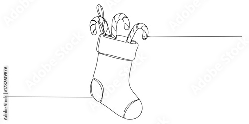 Continuous one line drawing of a Christmas stocking with candy canes, representing the sweet tradition, line art style vector illustration.