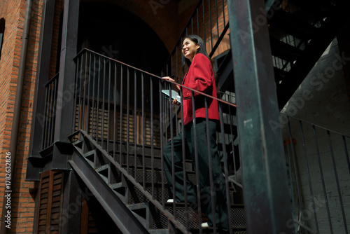 Businesswoman manager walking upstairs achieving career progress goals
