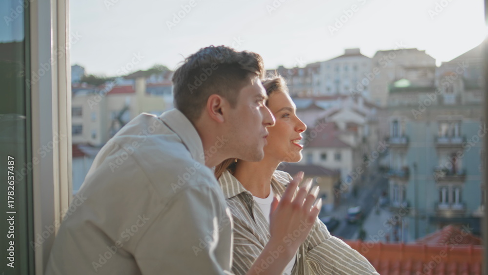 Obraz premium Smiling couple communicating balcony in evening closeup. Romantic people travel
