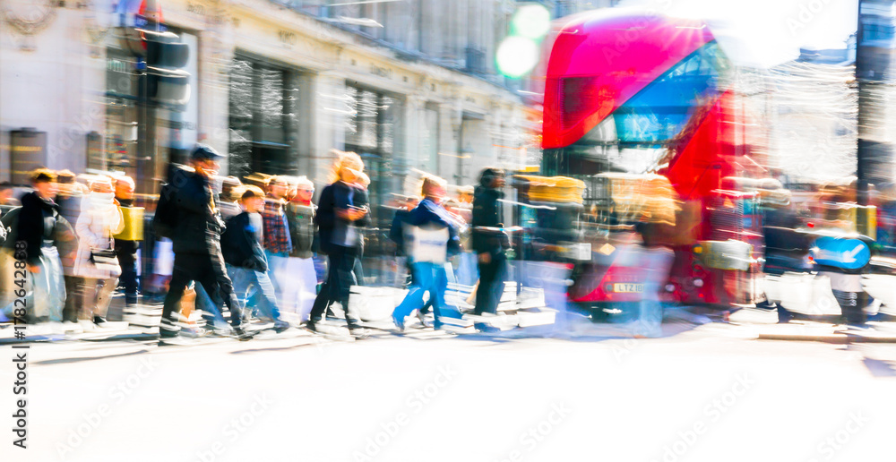Fototapeta premium Beautiful postmodernism motion of people walking in London street at sunny day. Shoppers and tourists crossing Oxford circus