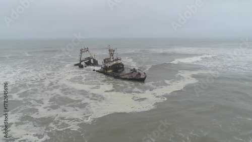 3 Namibia shipwreck Close Up , Drone Shot tracking in and tilting down of fishing vessel near Swakopmund  
