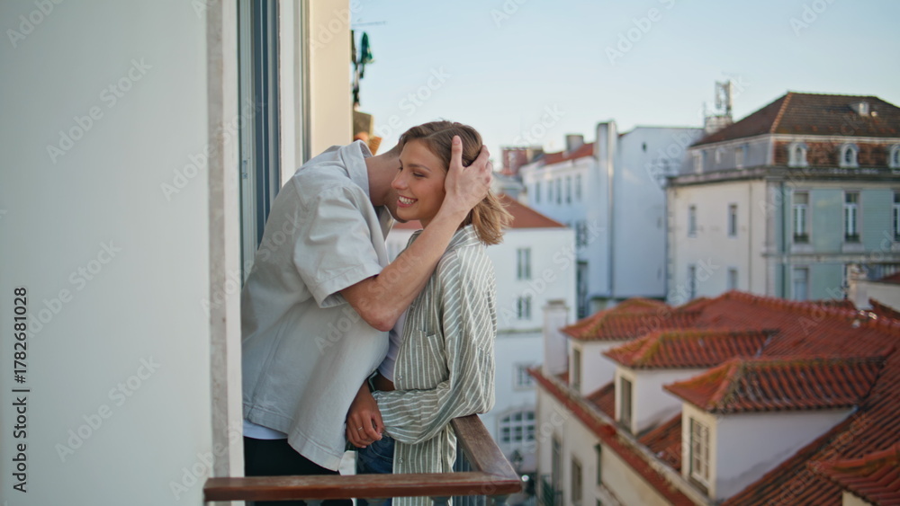 Naklejka premium Loving people hugging rooftops view. Affectionate boyfriend embracing on balcony