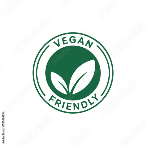 Green circular vegan friendly symbol with leaves and text on white background
