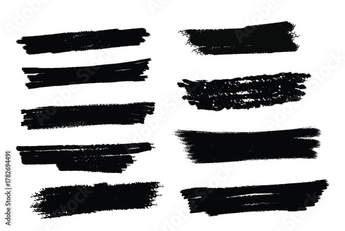 Collection of rough black brush stroke textures on a white background